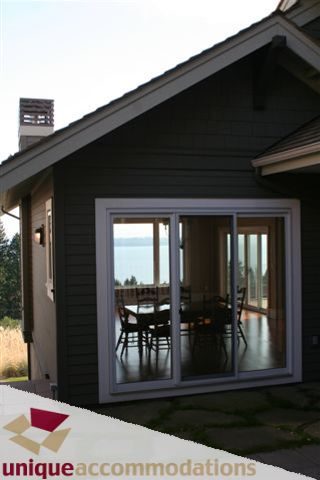 Furnished patio with sliding glass doors, overlooking the water. - 2550 Marr Creek Ct, West Vancouver