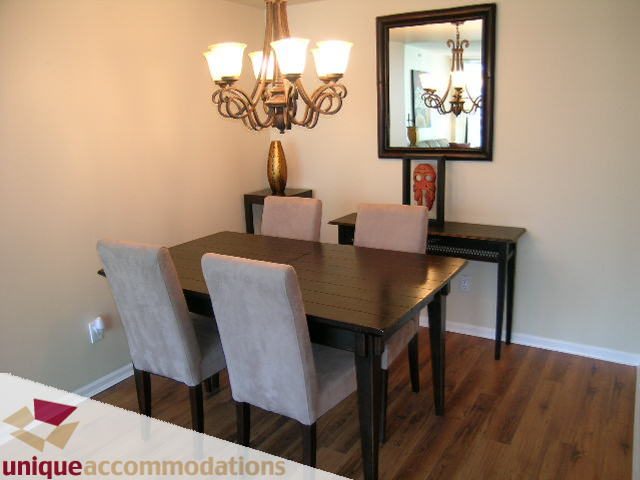 Furnished dining room with hardwood floors, chandelier, and mirror. - 2005 - 1238 Melville, Vancouver Downtown