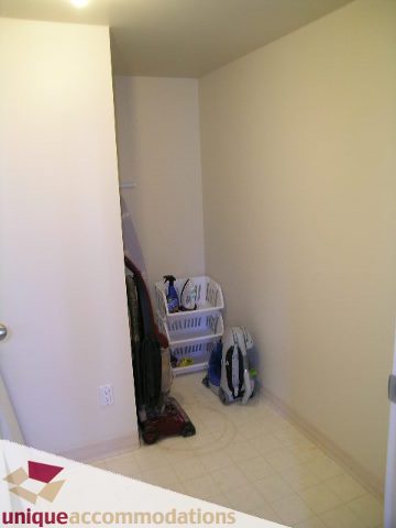Bright laundry room with white countertop and tiled floor. - 2005 - 1238 Melville, Vancouver Downtown