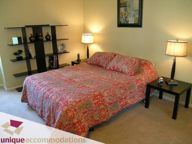 Furnished 2-bedroom condo with twin beds, patterned bedding, and modern decor. - 2005 - 1238 Melville, Vancouver Downtown