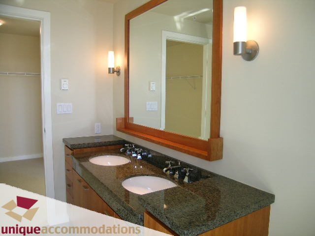 Bright bathroom with granite countertops and large mirror. - 3602 - 583 Beach Crescent, Vancouver Downtown