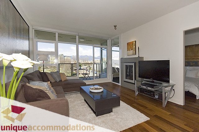 Furnished living room with hardwood floors, city view, and modern decor. - 505 - 1808 West 1st Avenue, Vancouver West Side