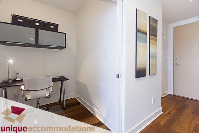 Furnished den with modern decor, hardwood floors, and sleek cabinets. - 505 - 1808 West 1st Avenue, Vancouver West Side