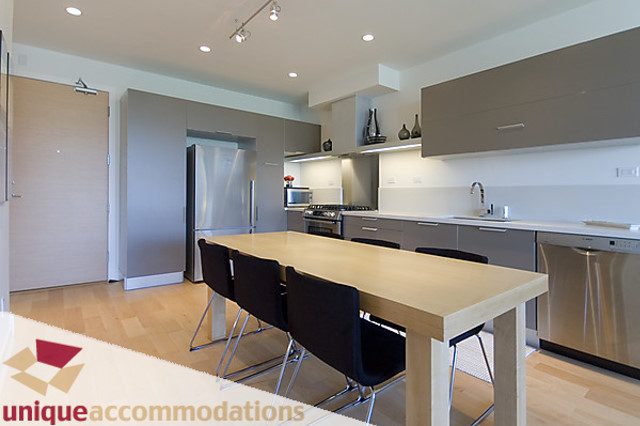 Bright kitchen with light wood countertops and hardwood floors, modern appliances. - 404 - 1808 West 1st Avenue, Vancouver West Side