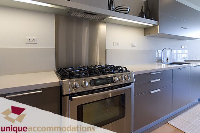 Bright kitchen with stainless steel appliances, white countertops, and modern cabinetry. - 404 - 1808 West 1st Avenue, Vancouver West Side