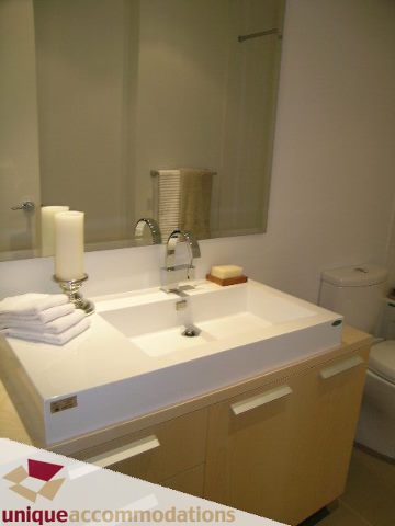 Furnished bathroom with modern sink, countertop, and mirror. - 307- 1808 West 1st Avenue, Vancouver West Side