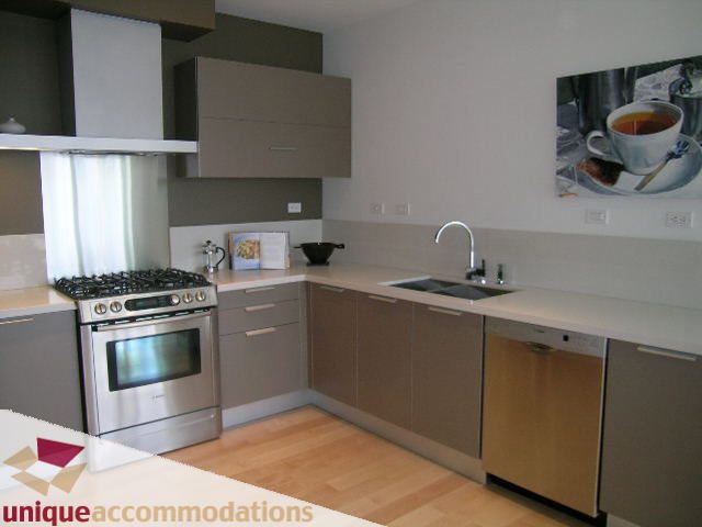 Bright kitchen with stainless steel appliances, light wood countertops, and hardwood floors. - 307- 1808 West 1st Avenue, Vancouver West Side