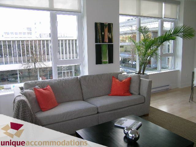 Bright living room with large windows, modern furniture, and a city view. - 307- 1808 West 1st Avenue, Vancouver West Side