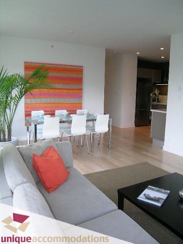 Spacious living room with modern decor, hardwood floors, and a vibrant abstract painting. - 307- 1808 West 1st Avenue, Vancouver West Side
