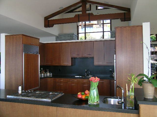 Bright kitchen with dark countertops, modern cabinets, and a view of the outdoors. - 2456 Hudson Court, West Vancouver