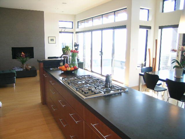 Bright kitchen with dark countertops, hardwood floors, and a city view. - 2456 Hudson Court, West Vancouver