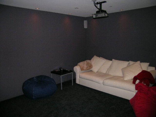 Living room with white couches, bean bag, and dark walls. - 2456 Hudson Court, West Vancouver