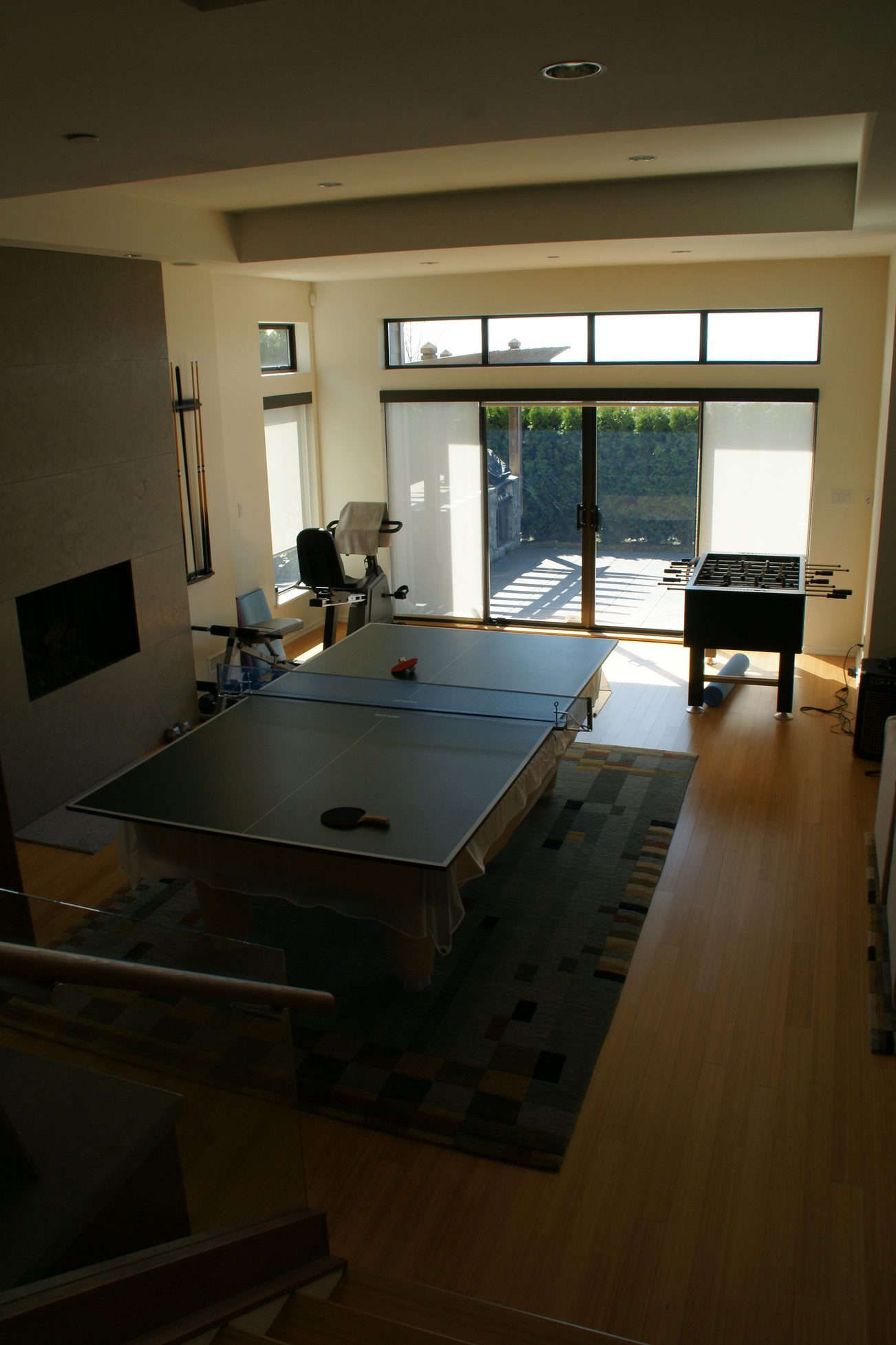 Game room with ping pong table, hardwood floors, and large windows. - 2456 Hudson Court, West Vancouver
