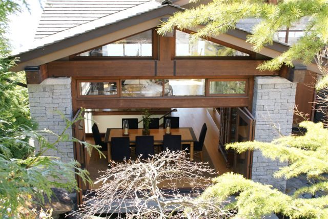 Modern living room with large windows and stone accents. - 2456 Hudson Court, West Vancouver