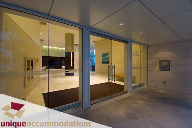 Furnished living room with large windows, modern decor, and city view. - 903 - 1139 West Cordova Street, Vancouver Downtown
