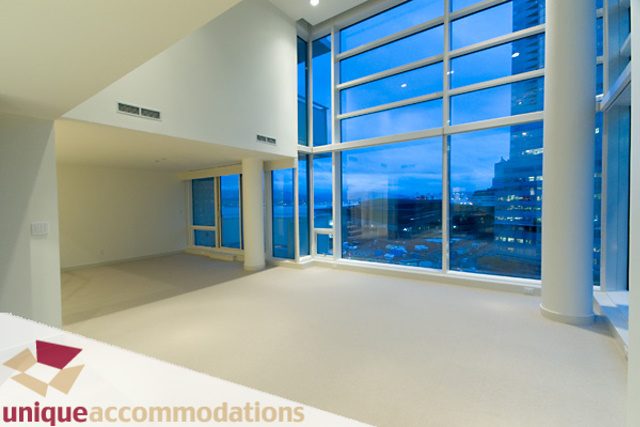Spacious living room with large windows offering a stunning city view. - 903 - 1139 West Cordova Street, Vancouver Downtown