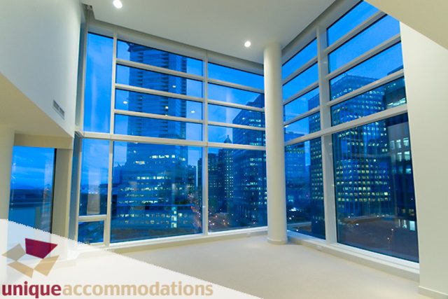 Bright living room with large windows showcasing city skyline, modern furnishings. - 903 - 1139 West Cordova Street, Vancouver Downtown
