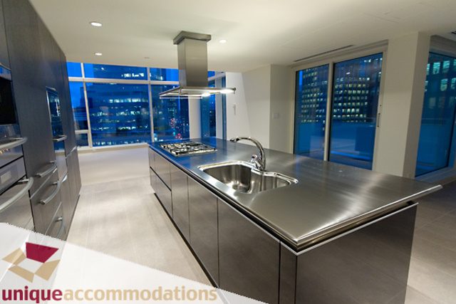 Bright kitchen with stainless steel countertops, modern appliances, and city view windows. - 903 - 1139 West Cordova Street, Vancouver Downtown