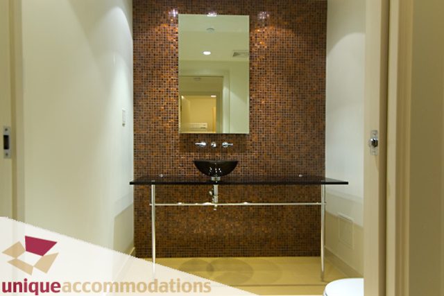 Furnished bathroom with mosaic tile backsplash and modern sink. - 903 - 1139 West Cordova Street, Vancouver Downtown