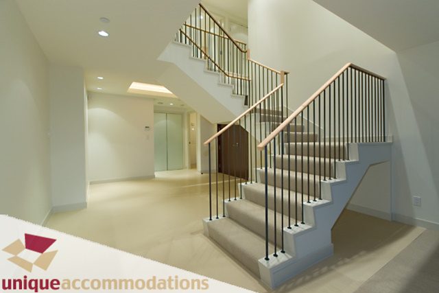 Spacious living room with modern staircase and neutral decor. - 903 - 1139 West Cordova Street, Vancouver Downtown