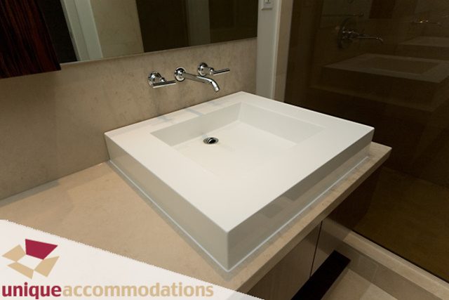 Modern bathroom with sleek white sink and countertop, light beige walls. - 903 - 1139 West Cordova Street, Vancouver Downtown