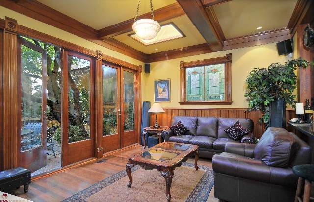 Spacious living room with large windows, hardwood floors, and a cozy seating area. - 1150 Haro Street, Vancouver Downtown