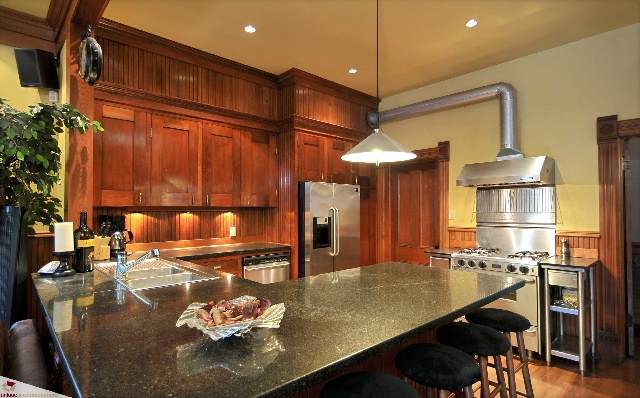 Bright kitchen with granite countertops, stainless steel appliances, and wooden cabinets. - 1150 Haro Street, Vancouver Downtown