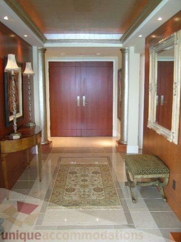 Foyer with wooden accents, marble flooring, and a large door leading to the living area. - 802 - 323 Jervis Street, Vancouver Downtown