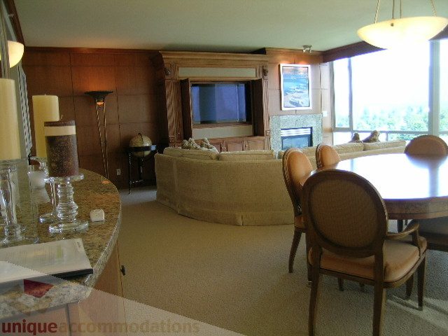 Furnished living room with a large window, modern decor, and a cozy fireplace. - 802 - 323 Jervis Street, Vancouver Downtown