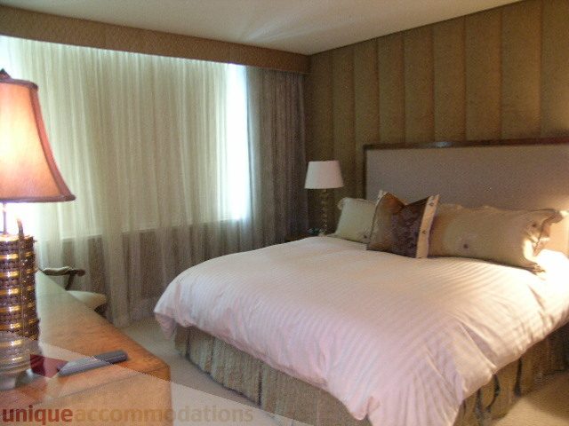 Spacious bedroom with plush bedding and elegant lamp on nightstand. - 802 - 323 Jervis Street, Vancouver Downtown