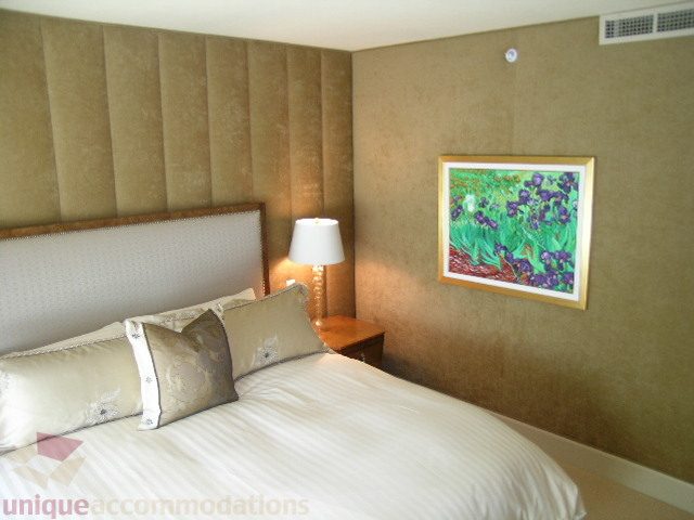 Spacious bedroom with plush headboard, wall art, and soft lighting. - 802 - 323 Jervis Street, Vancouver Downtown