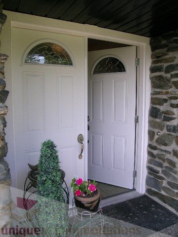 Front door with stained glass and stone accents. - 4104 Sunnycrest drive, North Vancouver