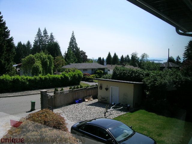 Bright living room with city view and lush greenery. - 4104 Sunnycrest drive, North Vancouver