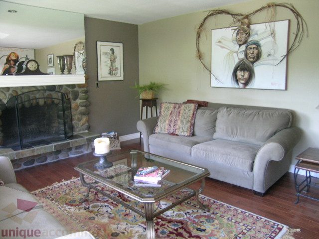 Furnished living room with a fireplace, hardwood floors, and a large area rug. - 4104 Sunnycrest drive, North Vancouver
