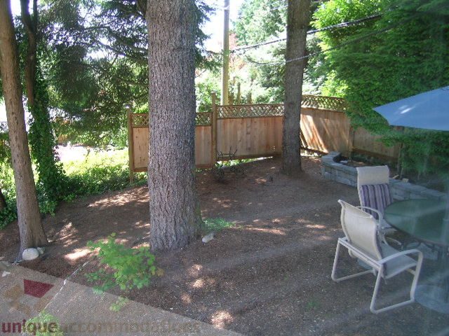 Furnished patio with wooden fencing, trees, and outdoor furniture. - 4104 Sunnycrest drive, North Vancouver