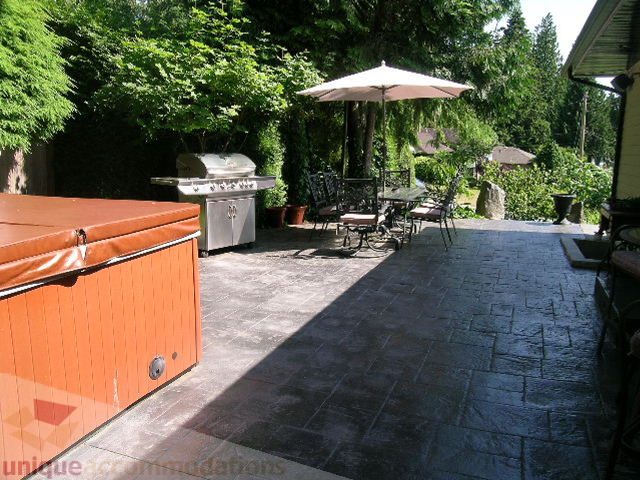 Furnished patio with outdoor grill, umbrella, and stone flooring. - 4104 Sunnycrest drive, North Vancouver
