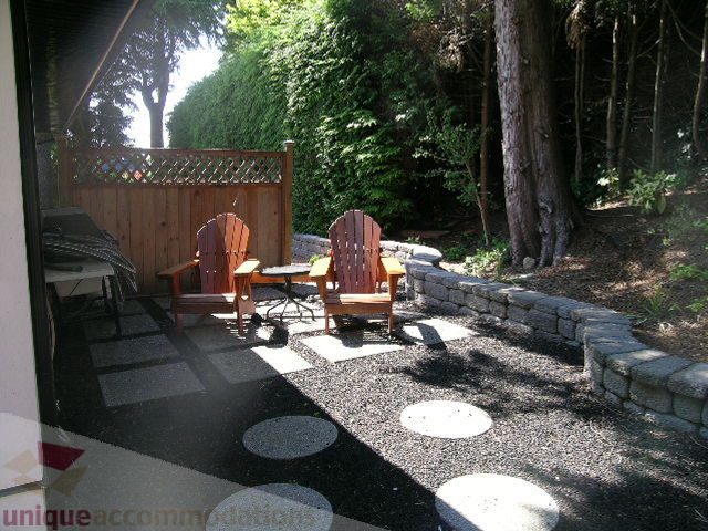 Furnished patio with Adirondack chairs and stone pathways. - 4104 Sunnycrest drive, North Vancouver