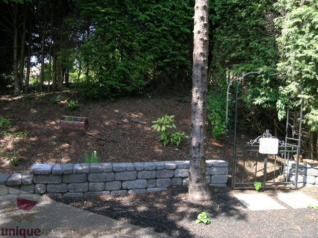 Landscaped garden with stone retaining wall and mulched area. - 4104 Sunnycrest drive, North Vancouver