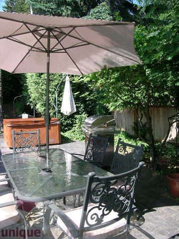 Furnished patio with glass table, metal chairs, and outdoor umbrella. - 4104 Sunnycrest drive, North Vancouver