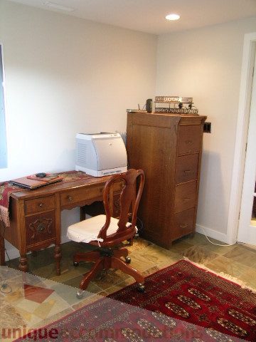 Bright home office with wooden furniture and a patterned rug. - 4104 Sunnycrest drive, North Vancouver