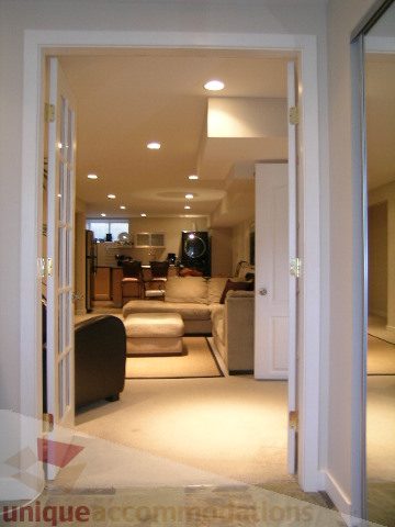Spacious living room with modern furnishings and a cozy sofa. - 4104 Sunnycrest drive, North Vancouver