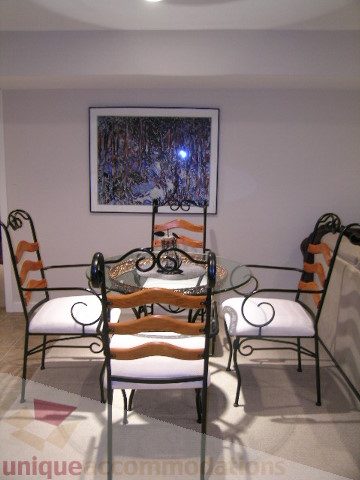 Dining area with ornate chairs and abstract art on wall. - 4104 Sunnycrest drive, North Vancouver