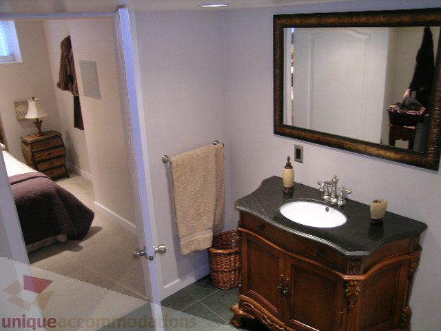 Furnished bathroom with dark countertop and wooden vanity. - 4104 Sunnycrest drive, North Vancouver