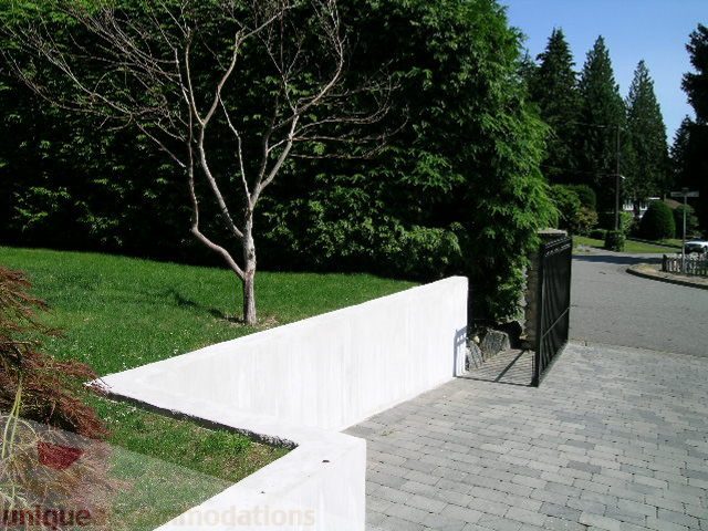 Paved walkway leading to a house with lush greenery and trees. - 4104 Sunnycrest drive, North Vancouver