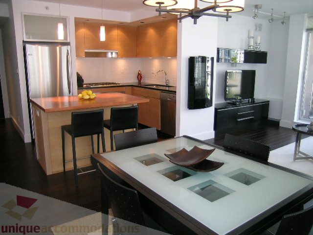 Modern kitchen with sleek countertops and hardwood floors. - 705 - 1055 Homer Street, Vancouver Downtown