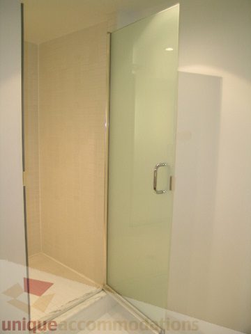 Bathroom with frosted glass shower doors and white countertop. - 705 - 1055 Homer Street, Vancouver Downtown