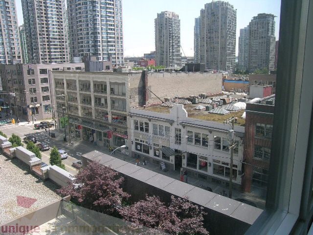 Bright living room with city view and modern furnishings. - 705 - 1055 Homer Street, Vancouver Downtown