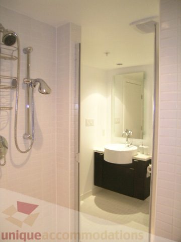 Bright bathroom with modern fixtures and white tiles. - 705 - 1055 Homer Street, Vancouver Downtown