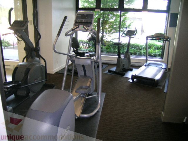 Bright fitness room with cardio equipment and large windows. - 705 - 1055 Homer Street, Vancouver Downtown