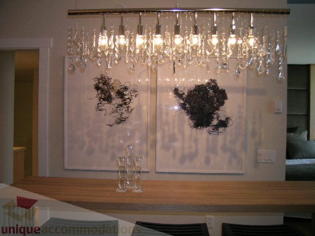 Furnished living room with wooden countertop and modern chandelier. - 208 - 1833 Crowe St., Vancouver West Side